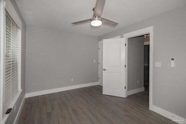 unfurnished bedroom featuring dark hardwood / wood-style floors and ceiling fan