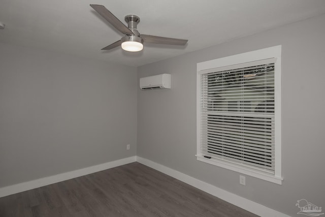 spare room with a wall unit AC, ceiling fan, and dark hardwood / wood-style flooring