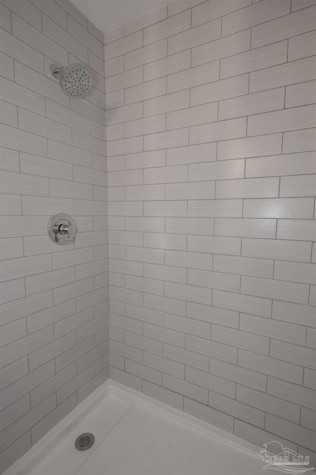 bathroom with a tile shower