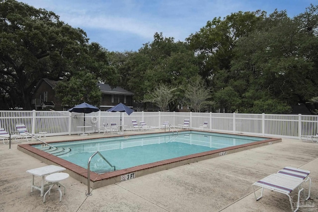 view of swimming pool featuring a patio area