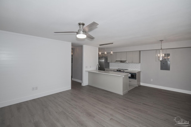 kitchen featuring backsplash, electric panel, decorative light fixtures, gray cabinets, and appliances with stainless steel finishes