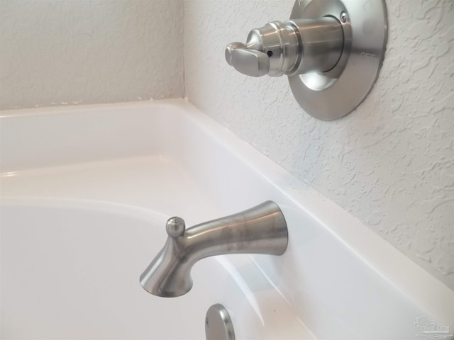 interior details featuring a bathing tub and sink