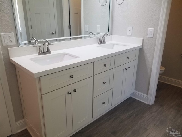 bathroom featuring hardwood / wood-style floors, vanity, and toilet