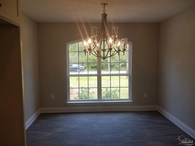 interior space with dark hardwood / wood-style floors and an inviting chandelier