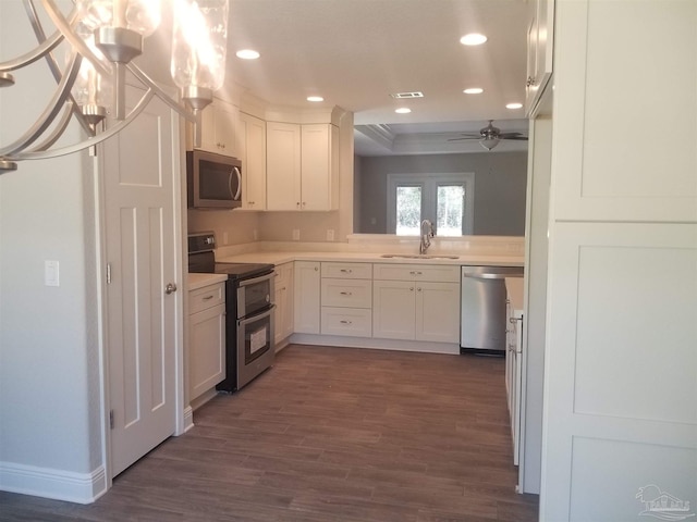 kitchen featuring dark hardwood / wood-style floors, sink, white cabinetry, stainless steel appliances, and ceiling fan