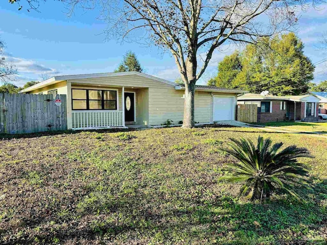 ranch-style home featuring a garage and a front lawn