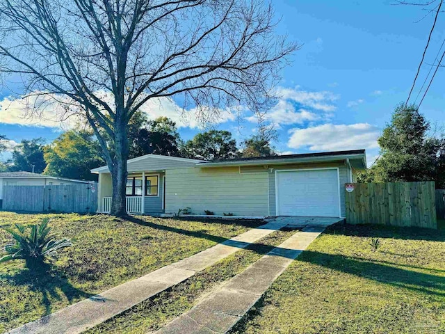 ranch-style home with a garage and a front lawn