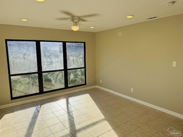 tiled empty room with ceiling fan