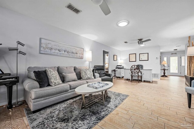 living room with ceiling fan and hardwood / wood-style floors