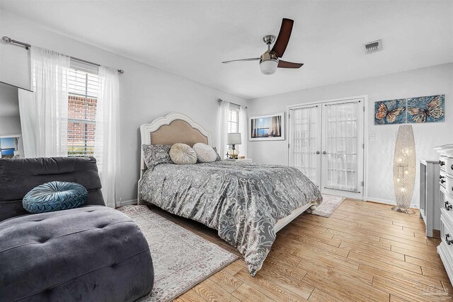 bedroom with access to outside, ceiling fan, and light hardwood / wood-style flooring