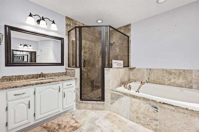 bathroom with vanity and separate shower and tub