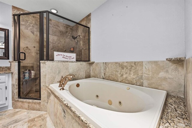 bathroom with shower with separate bathtub