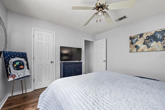 bedroom with dark hardwood / wood-style floors and ceiling fan