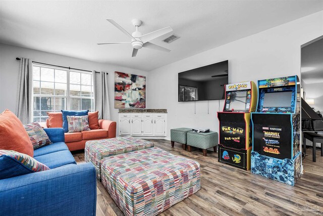 living room featuring hardwood / wood-style floors and ceiling fan