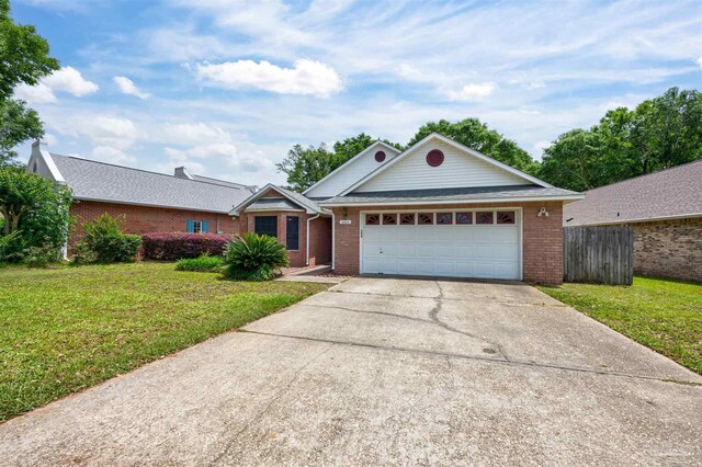 ranch-style house featuring a front yard and a garage