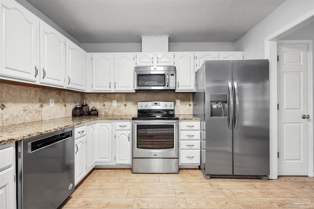 kitchen featuring light hardwood / wood-style flooring, stainless steel appliances, white cabinetry, and light stone countertops