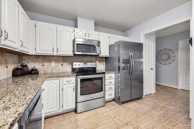 kitchen featuring light hardwood / wood-style flooring, stainless steel appliances, and white cabinetry