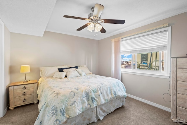 carpeted bedroom with ornamental molding and ceiling fan