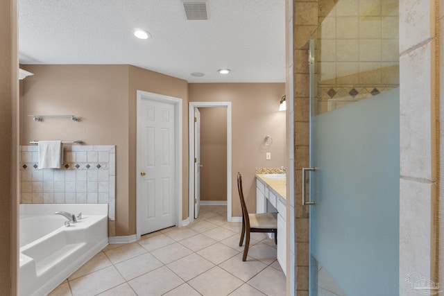2215 Seascale Ct, Navarre, FL 32566 - full bath with a stall shower, tile patterned floors, a garden tub, vanity, and baseboards