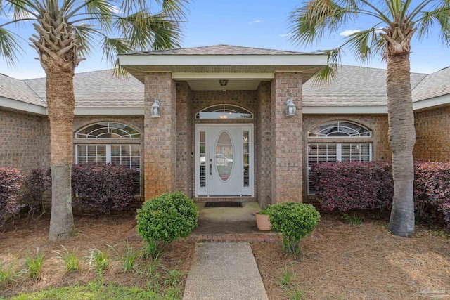 2215 Seascale Ct, Navarre, FL 32566 - view of exterior entry featuring roof with shingles and brick siding