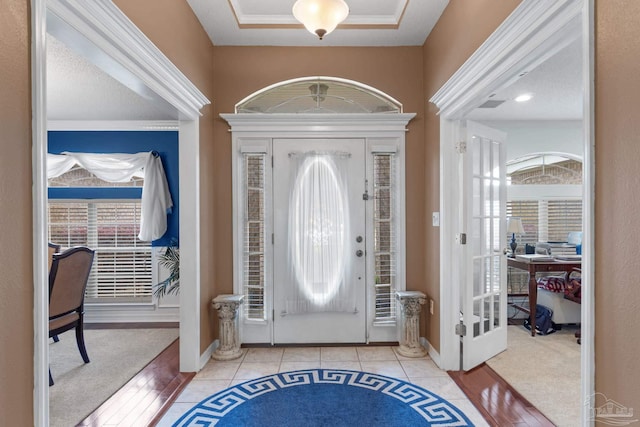 2215 Seascale Ct, Navarre, FL 32566 - entryway with tile patterned flooring, french doors, ornamental molding, and baseboards