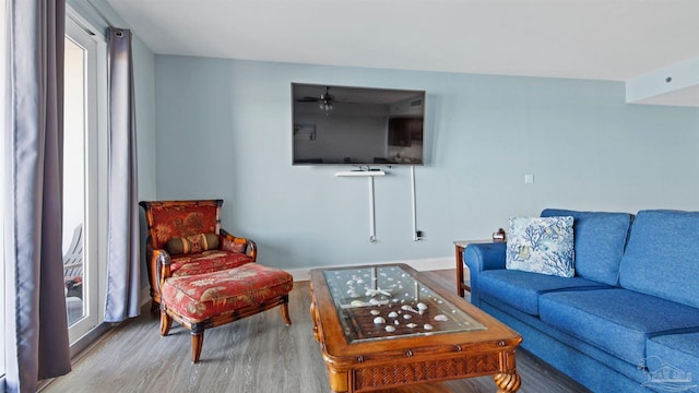 living room featuring ceiling fan and hardwood / wood-style floors