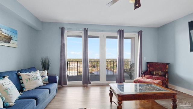 living room with light wood-type flooring and ceiling fan