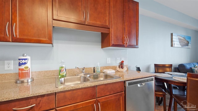 kitchen with dishwasher, sink, and light stone counters