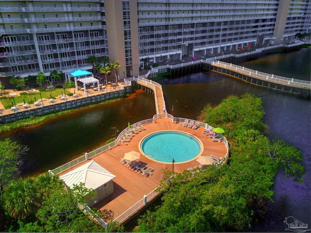 view of swimming pool featuring a jacuzzi and a water view