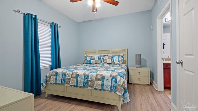 bedroom with connected bathroom, light hardwood / wood-style floors, and ceiling fan