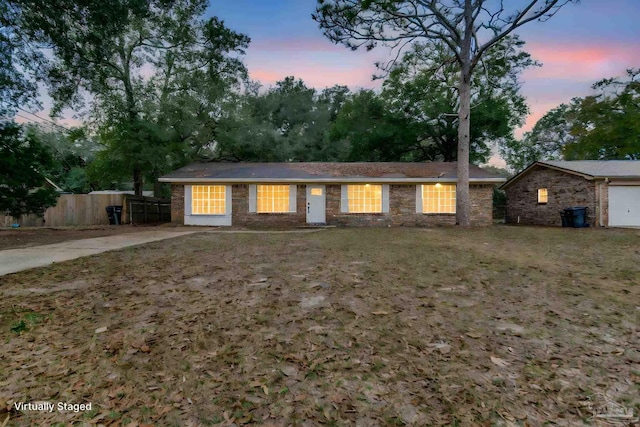 single story home featuring a yard