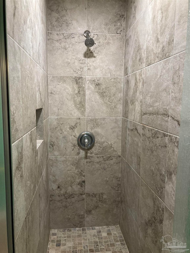 bathroom with a tile shower