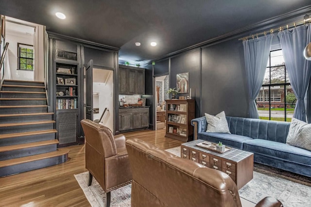 living room featuring crown molding and light wood-type flooring