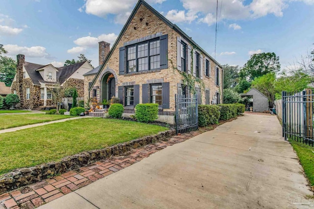 tudor home with a front lawn