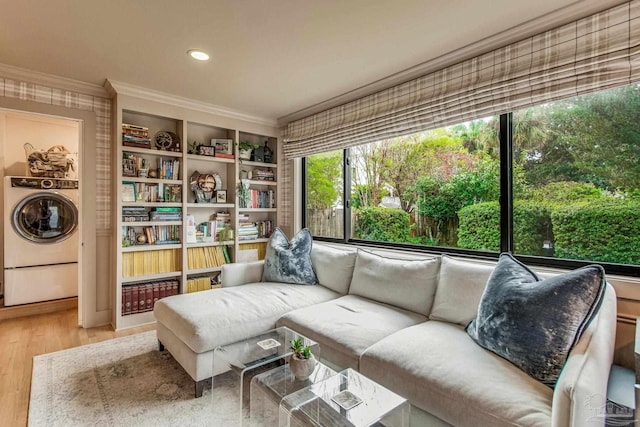 interior space with washer / clothes dryer, crown molding, built in shelves, and hardwood / wood-style flooring