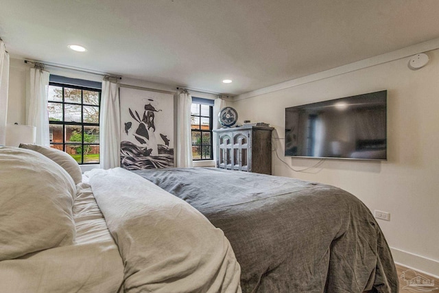 bedroom featuring hardwood / wood-style floors and multiple windows