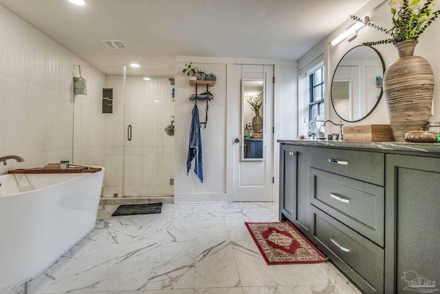 bathroom with vanity and independent shower and bath