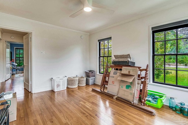 misc room featuring hardwood / wood-style floors, ceiling fan, a healthy amount of sunlight, and ornamental molding