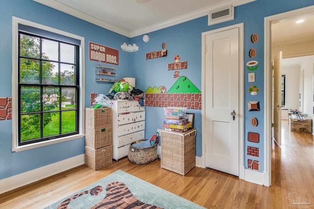 bedroom with crown molding and hardwood / wood-style flooring