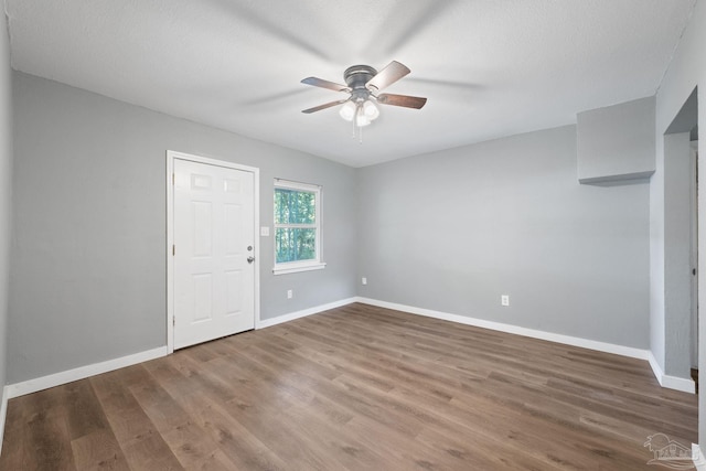 interior space featuring hardwood / wood-style floors, ceiling fan, and a textured ceiling