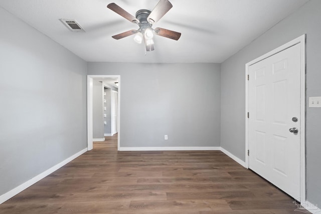 interior space with ceiling fan and dark hardwood / wood-style flooring