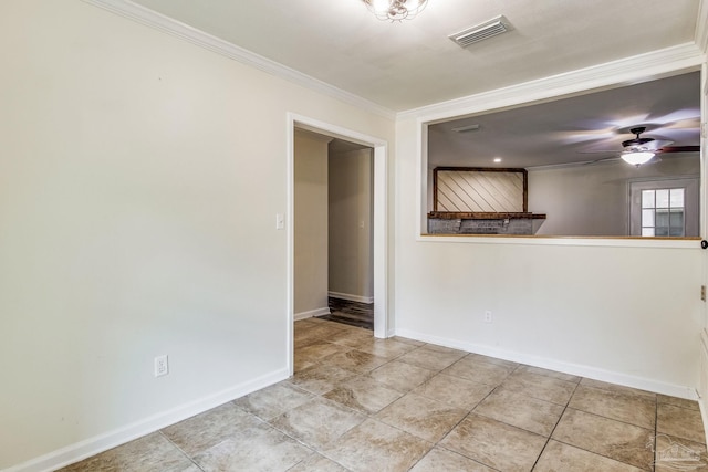 spare room with tile patterned floors, ornamental molding, and ceiling fan