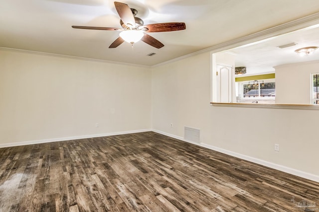 spare room with crown molding, ceiling fan, and dark hardwood / wood-style flooring