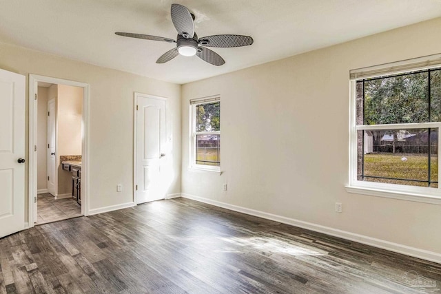 unfurnished bedroom with ceiling fan, dark hardwood / wood-style flooring, and ensuite bath