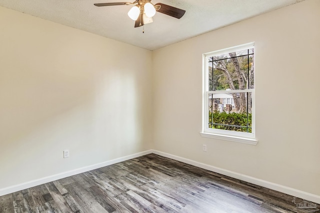 unfurnished room featuring dark hardwood / wood-style flooring, ceiling fan, and a textured ceiling