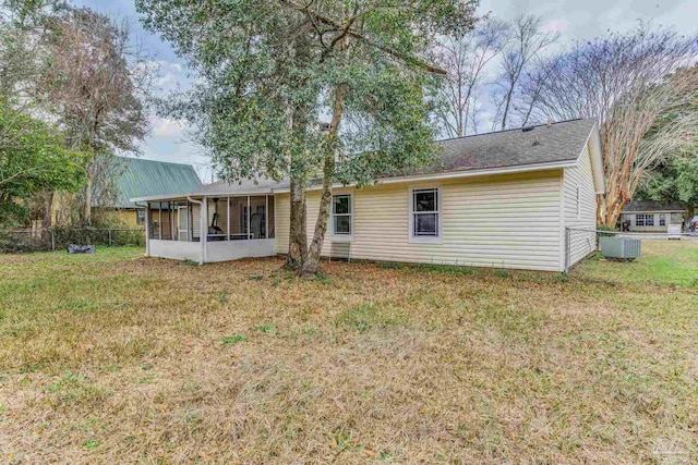 back of house featuring cooling unit, a yard, and a sunroom