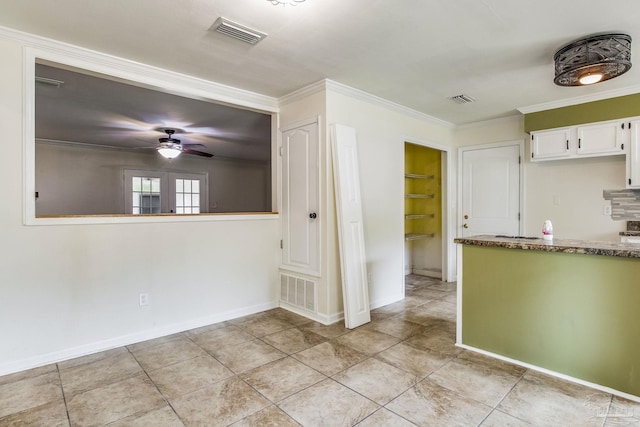 interior space featuring light tile patterned floors, built in features, ceiling fan, ornamental molding, and white cabinets