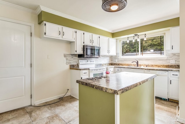 kitchen featuring a kitchen island, white cabinetry, sink, crown molding, and white appliances