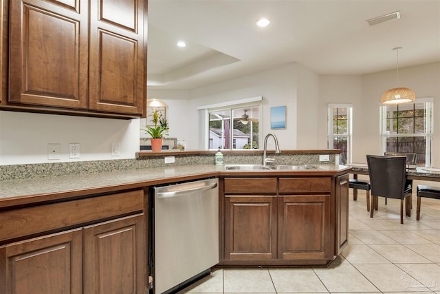 kitchen featuring pendant lighting, light tile patterned flooring, dishwasher, and sink