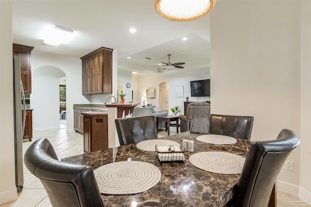 tiled dining area featuring sink and ceiling fan